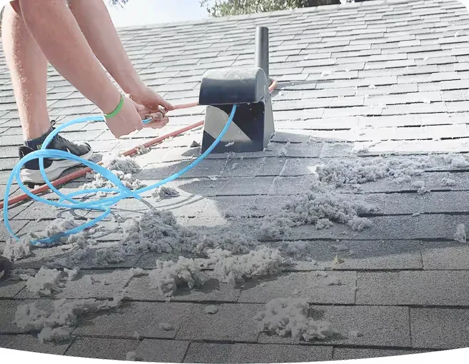 Superior Vents dryer-vent cleaning in progress — lint pulled clear of a rooftop vent